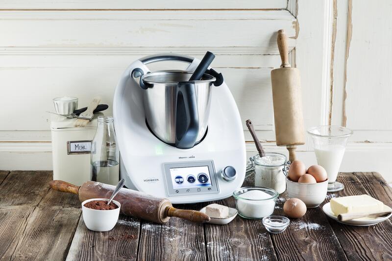 Thermomix® umgeben von Zutaten und Zubehör zum Backen